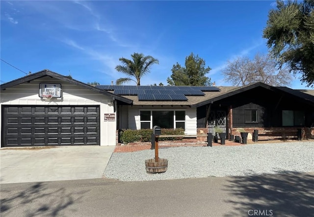 single story home featuring a garage and solar panels