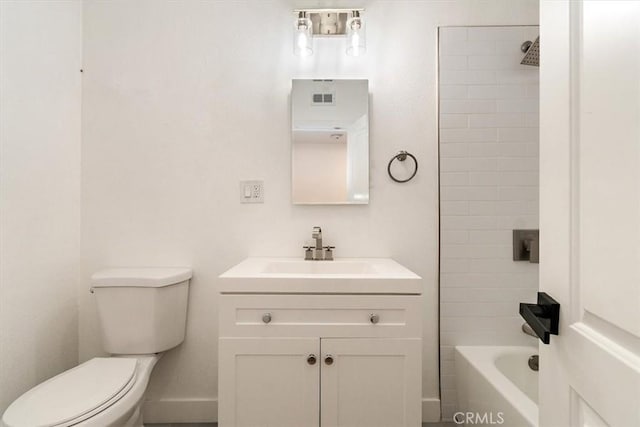 full bathroom with toilet, vanity, and tiled shower / bath