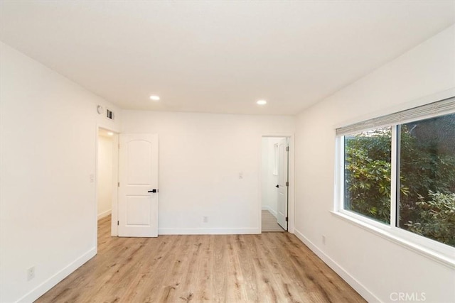 spare room with light wood-type flooring