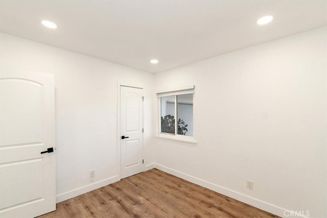 spare room with hardwood / wood-style flooring