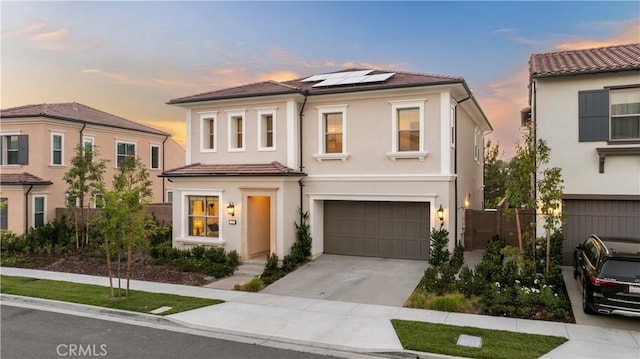 mediterranean / spanish-style home featuring a garage and solar panels