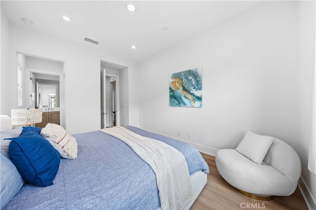 bedroom featuring light wood-style floors, recessed lighting, visible vents, and baseboards