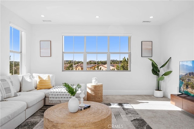 living room featuring carpet floors, baseboards, visible vents, and recessed lighting