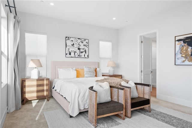 bedroom featuring baseboards, light carpet, and recessed lighting