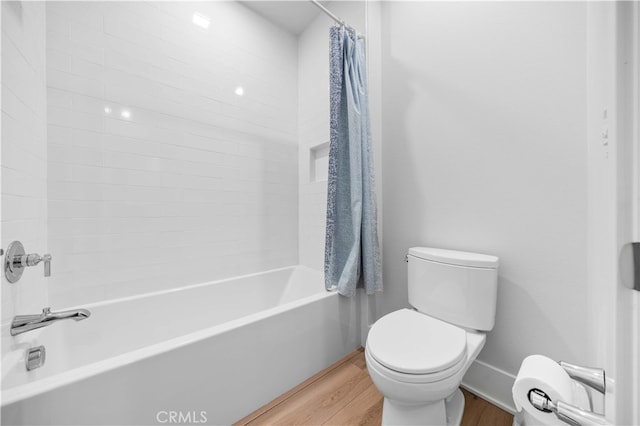 bathroom with shower / bath combination with curtain, baseboards, toilet, and wood finished floors