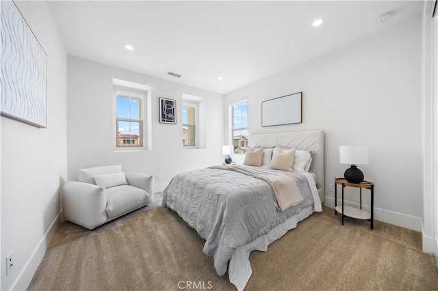 carpeted bedroom featuring baseboards, visible vents, and recessed lighting