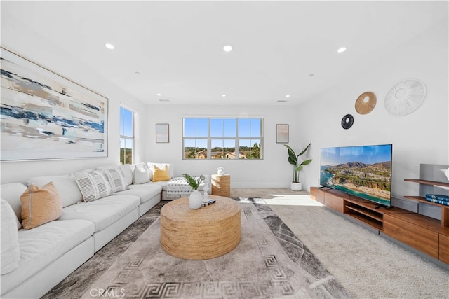 living area featuring baseboards and recessed lighting