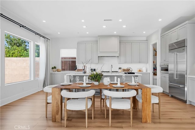 kitchen featuring appliances with stainless steel finishes, light wood-type flooring, light countertops, and recessed lighting