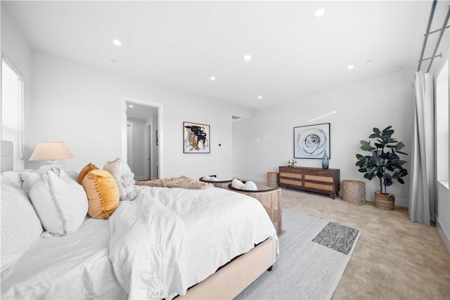 bedroom featuring light carpet and recessed lighting