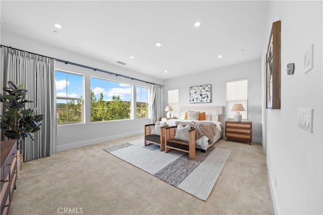 bedroom with recessed lighting, light colored carpet, and baseboards