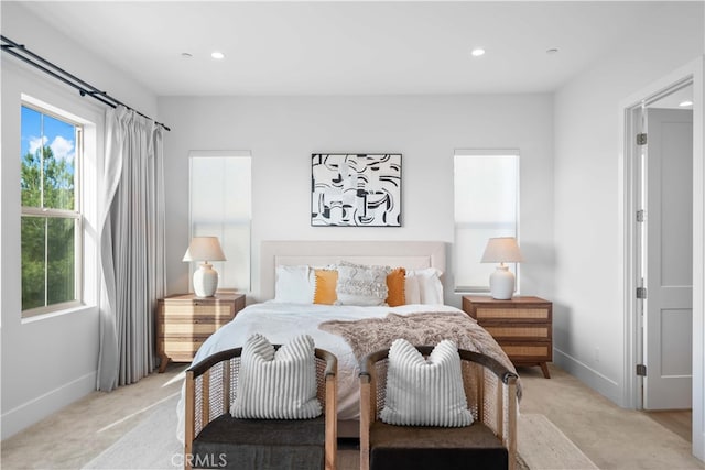 bedroom featuring light carpet, baseboards, and recessed lighting