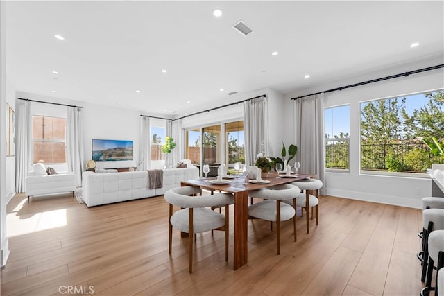 dining space featuring light wood-type flooring, visible vents, and recessed lighting