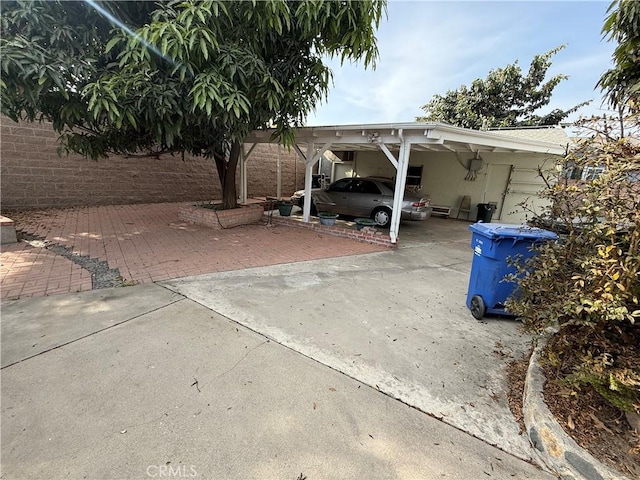 view of parking / parking lot featuring a carport