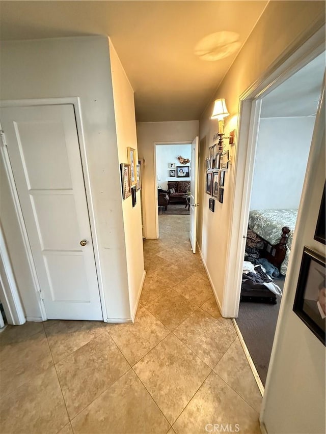 corridor with light tile patterned floors