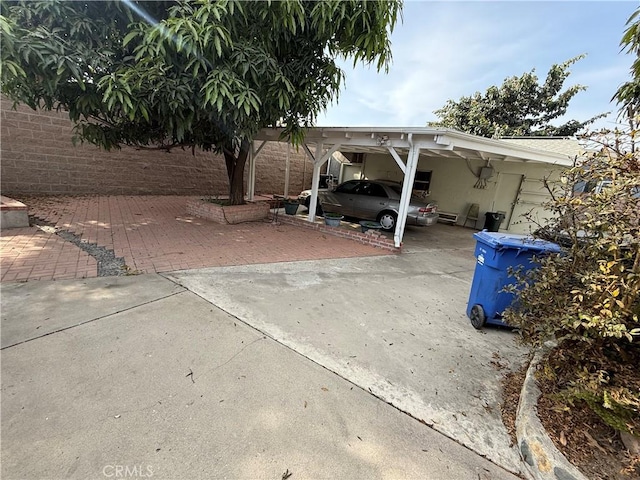 view of parking / parking lot featuring a carport