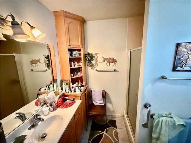 bathroom featuring vanity, tile patterned floors, and a shower with door