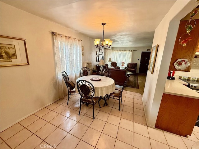 dining area with light tile patterned floors and a notable chandelier