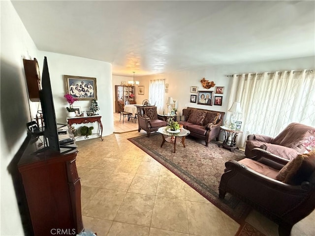 living room featuring light tile patterned floors and a notable chandelier