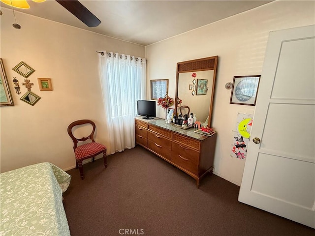 bedroom featuring ceiling fan and dark colored carpet