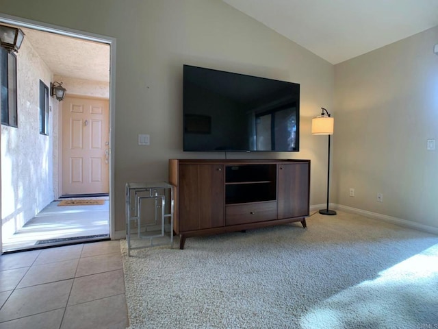 tiled living room featuring vaulted ceiling