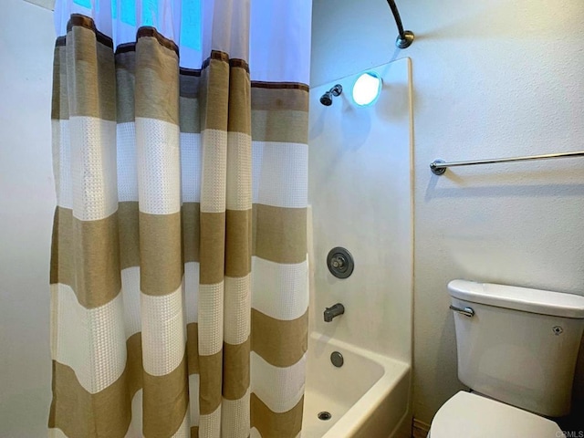 bathroom with toilet and shower / bathtub combination with curtain