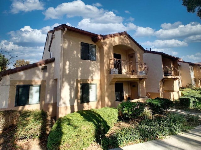 mediterranean / spanish-style home with a balcony