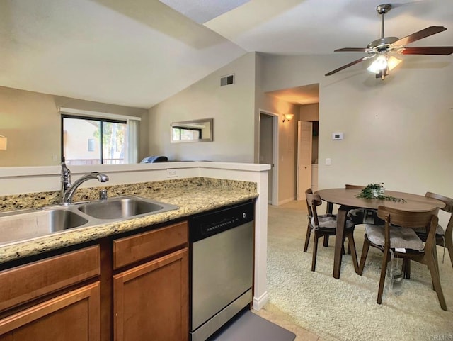 kitchen featuring lofted ceiling, sink, stainless steel dishwasher, light colored carpet, and ceiling fan