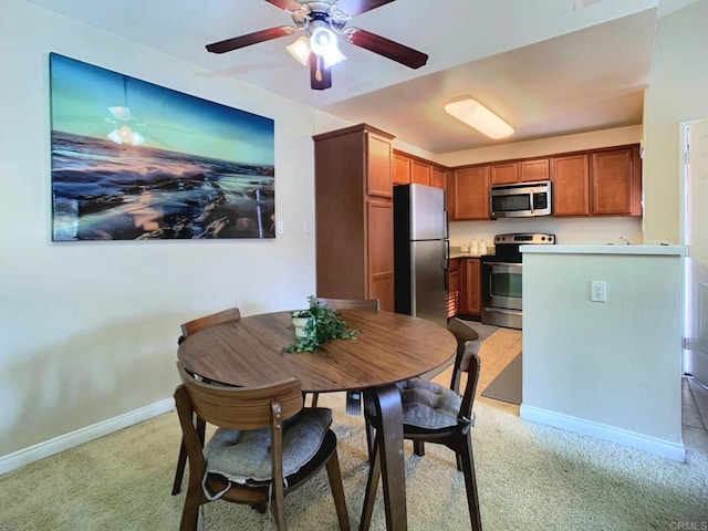 carpeted dining area featuring ceiling fan