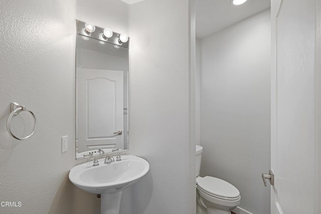 bathroom with toilet and a sink