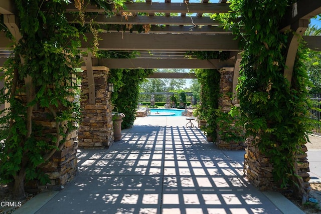 view of patio / terrace with an outdoor pool and a pergola