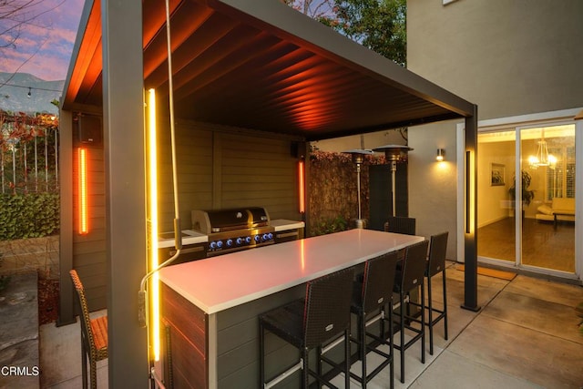 view of patio featuring an outdoor kitchen, grilling area, and outdoor wet bar