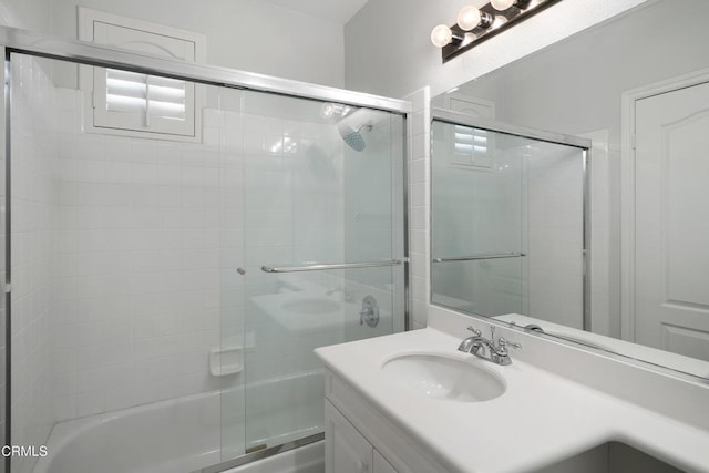 full bathroom featuring combined bath / shower with glass door and vanity