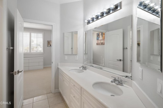 bathroom with double vanity, a sink, and tile patterned floors