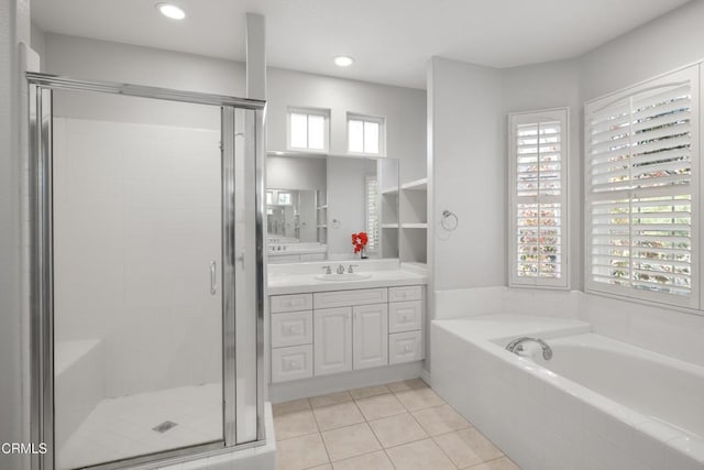 full bath with a garden tub, a shower stall, vanity, and tile patterned floors