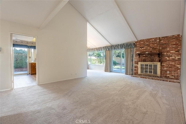 unfurnished living room featuring a brick fireplace, light colored carpet, and vaulted ceiling with beams