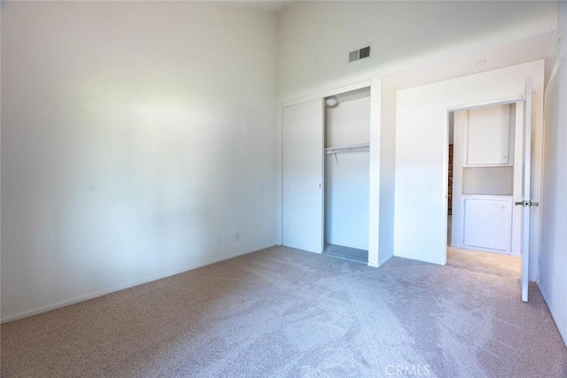 unfurnished bedroom featuring a closet and carpet floors