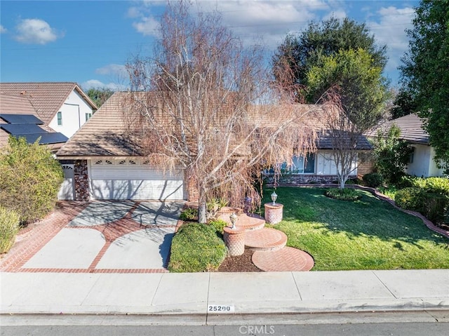 view of front of home with a front yard and a garage