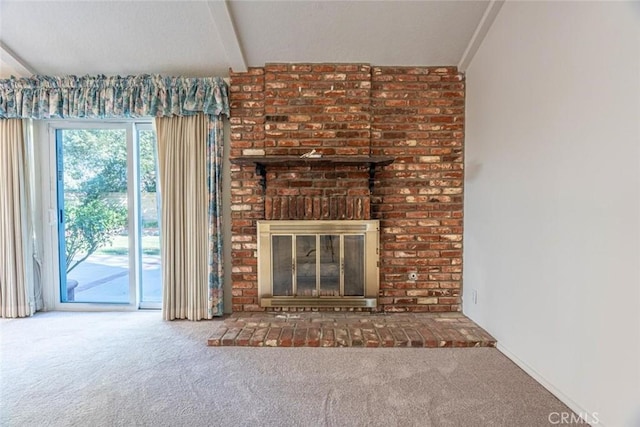 unfurnished living room with carpet floors and a fireplace