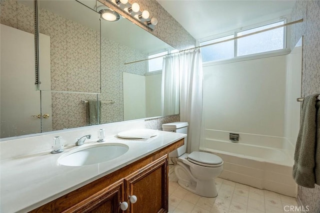 full bathroom featuring toilet, a healthy amount of sunlight, vanity, and shower / tub combo with curtain