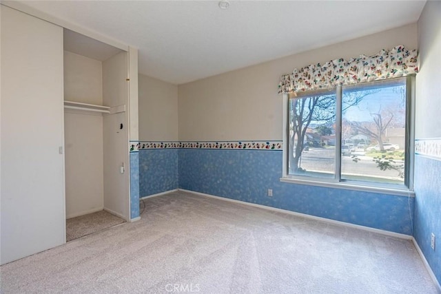 unfurnished bedroom featuring carpet floors and a closet