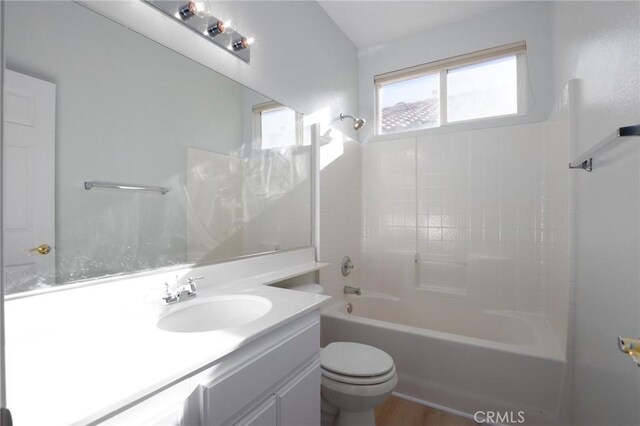 full bathroom featuring toilet, shower / bathtub combination, wood-type flooring, and vanity