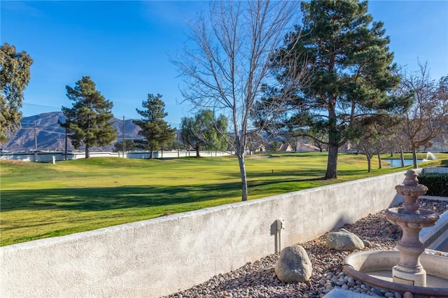 surrounding community with a lawn and a water view