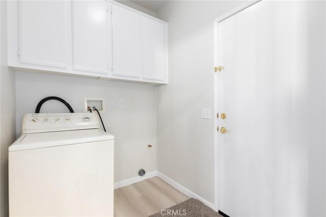 laundry area with washer / dryer, cabinets, and light wood-type flooring