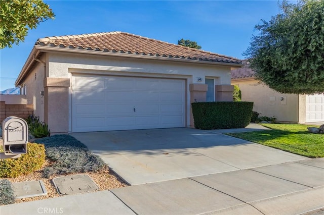 mediterranean / spanish-style home with a garage