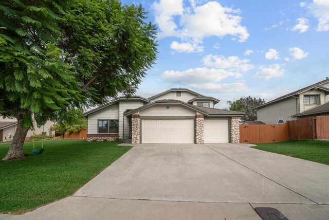 view of front of house with a garage and a front yard