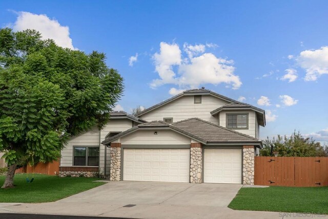 view of property with a front yard and a garage