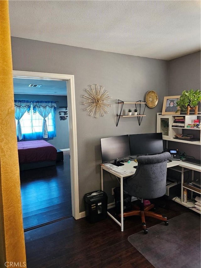 office space with wood-type flooring and a textured ceiling