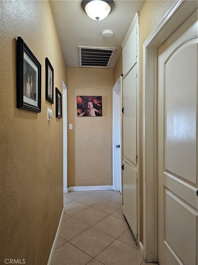 corridor with light tile patterned floors