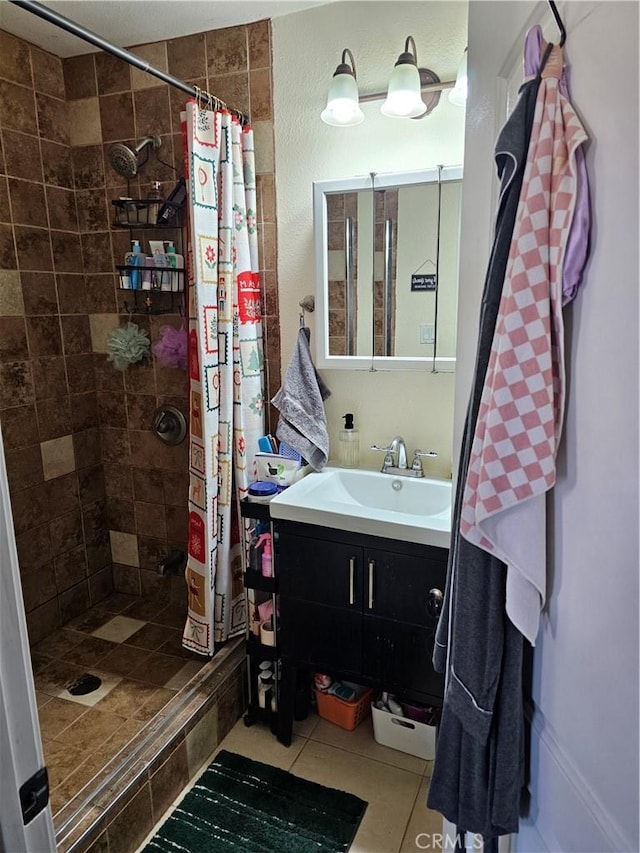 bathroom featuring a shower with shower curtain, tile patterned floors, and vanity