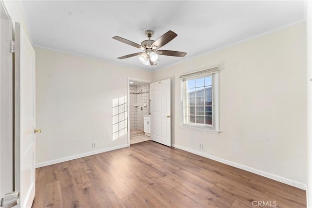 unfurnished bedroom with ceiling fan, hardwood / wood-style floors, and ornamental molding